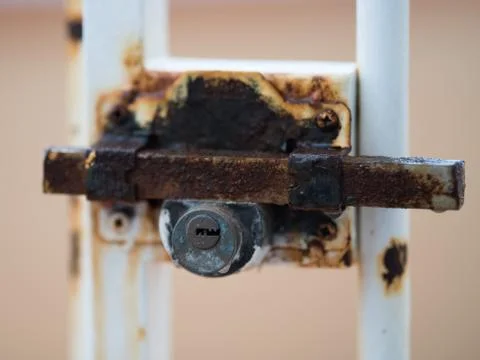 Rusty lock on the door dripping rain Stock Photos