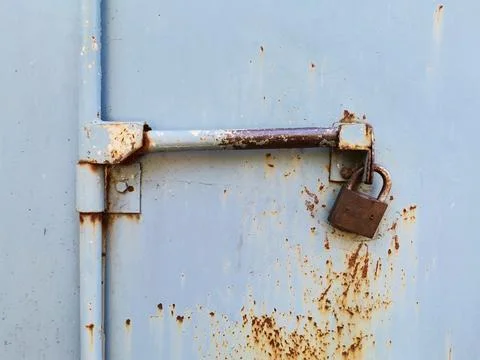The rusty lock of the iron door. Stock Photos
