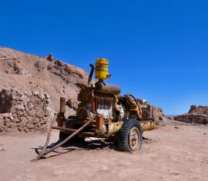 Rusty machine trailer in Atacama salt desert landscape before old mine, Chile Fotos Stock