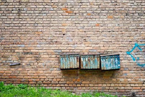 Rusty mailboxes on the brick grunge wall Stock Photos
