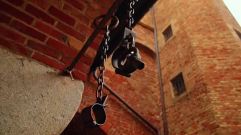 Rusty medieval torture devices hanging in a dungeon Stock Footage 312207832