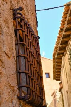 Rusty medieval window grid on an old wall Stock Photos