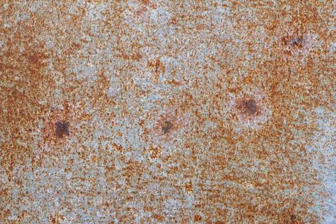 Rusty metal background.Rusty metallic texture.Bright orange rust through the  Stock Photos