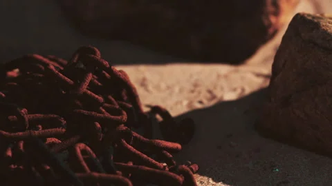 Rusty metal chains scattered on ground in warm sunlight during afternoon Stock Footage 340214372