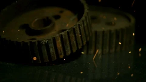 Rusty metal gear wheels rolling with orange flying sparks Stock Footage 327631480