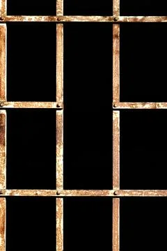 Rusty metal grid pattern against a black background Stock Photos