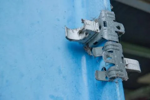 Rusty Metal Hinge on Blue Surface Stock Photos