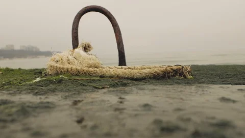 Rusty metal hook on a pier in a rope Stock Footage 103354675