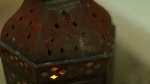 Rusty metal lantern with orange light glow. pan cu Stock Footage 107279427