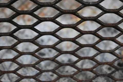 Rusty metal mesh with blurred snow background Stock Photos