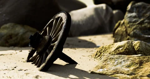 Rusty metal object lying on the sandy beach among large stones at dawn Stock Footage 313930180