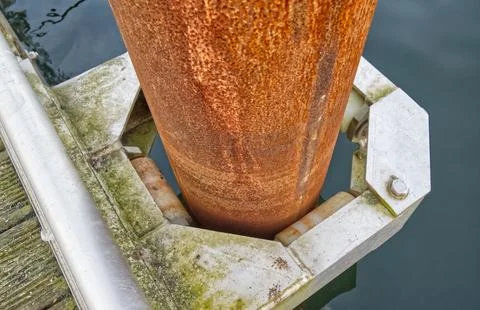 Rusty Metal Pole in Water with Bracket Stock Photos