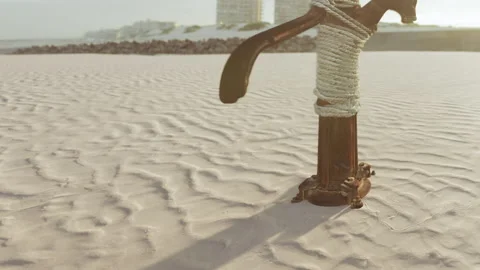 Rusty metal post stands on sandy beach during late afternoon sun Stock Footage 340994993