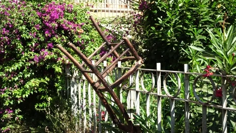 Rusty metal railing with geometric pattern with green plants in the background Stock Footage 143038908