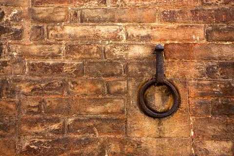 A rusty metal ring embedded in a brick wall. Copy space Stock Photos