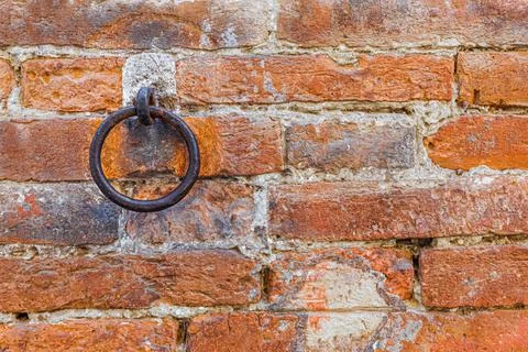 A rusty metal ring embedded in a brick wall. Copy space Stock Photos
