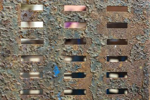 Rusty metal sheet with rectangular holes pattern. Stock Photos