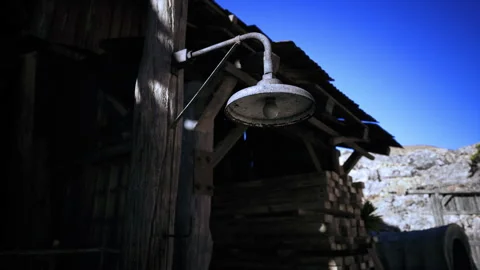 Rusty metal showerhead with blue sky and rugged terrain description Stock Footage 340663156