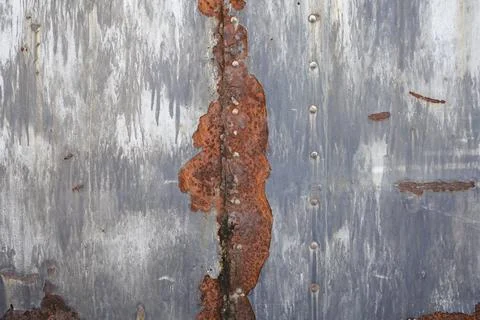 Rusty metal texture with rivets over red background . metal rusty plate tex.. Stock Photos