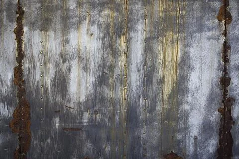 Rusty metal texture with rivets over red background . metal rusty plate textu Stock Photos