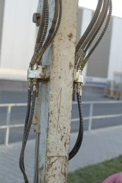 Rusty metal utility pole with cables Stockfoto's