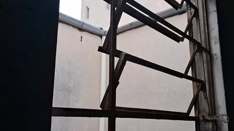 Rusty metal window frame opening slowly in urban motion video animation Stock Footage 339374515