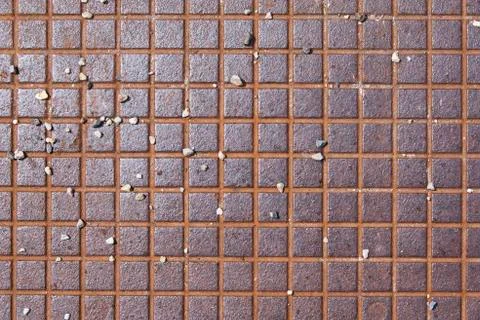 Rusty metallic square textured surface with pebbles Stock Photos