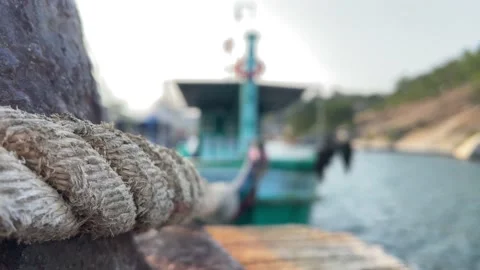 Thick Boat Ropes Tied To An Old Rusty Bollard Stock Photo