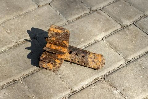 Rusty mortar shell on asphalt on a bright sunny day Stock Photos