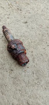 Rusty motorcycle spark plug on the floor Foto stock