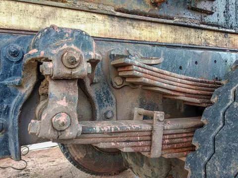 Rusty, multi-layered leaf spring suspension system on an industrial vehicle Stock Photos