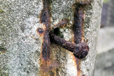 A rusty nail in the column Stock Photos