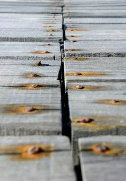 Rusty nails hammered on the boards rot Stock Photos