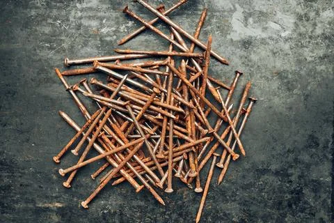 Rusty nails on steel surface. Tools for maintenance. Hardware tools to fix... Stock Photos
