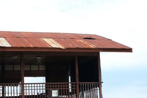 Rusty old barns - rusted corrugated iron tin roofs of old barracks. Stock Photos