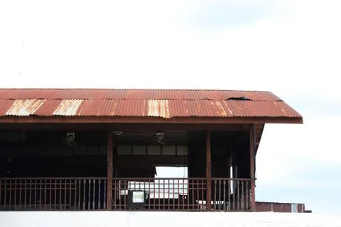 Rusty old barns - rusted corrugated iron tin roofs of old barracks. Stock Photos