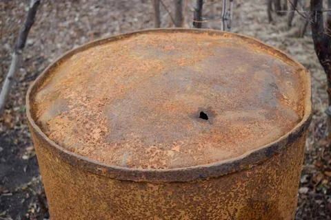 Rusty old barrel with hole in bottom vintage in garden Stock Photos