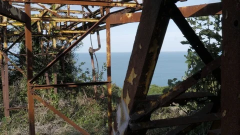 Rusty old damaged cable chair lift iron structure on the top hill edge of Stock Footage 119098304
