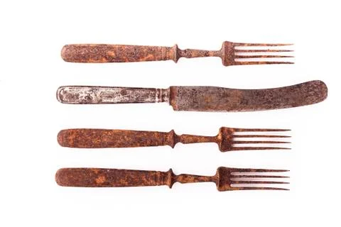 Rusty old fork and knife. Closeup isolated on white background Stock Photos