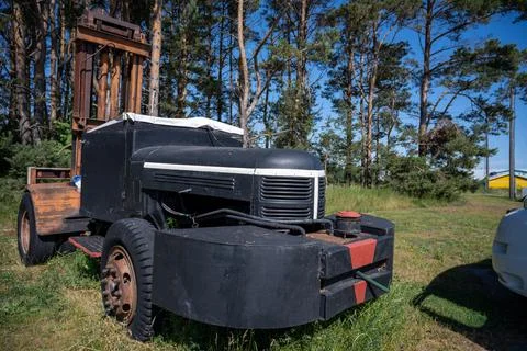 A rusty old forklift in a pine tree forest Stock Photos