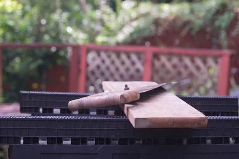 Rusty Old Hand Saw Resting on Wooden Board Outdoors Stock Photos
