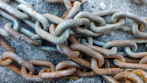 Rusty Old Iron Chains Tangled on Concrete Ground Photos