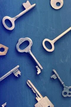 Rusty old keys locks - on dark wooden rustic background Stock Photos