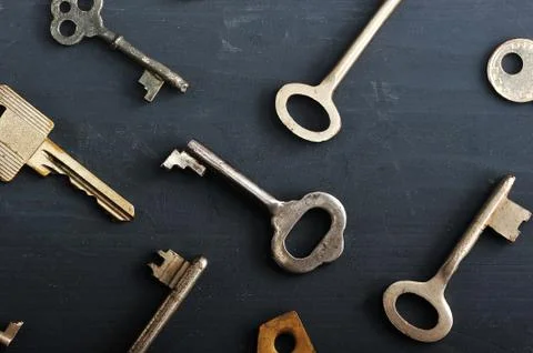 Rusty old keys locks - on dark wooden rustic background Stock Photos