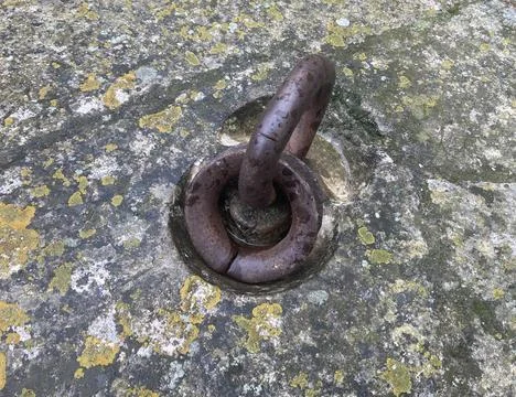 Rusty old metal ring embedded into a concrete bock Stock Photos
