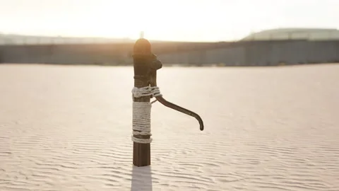 Rusty old metal water pump on sand beach Stock Footage 236411581