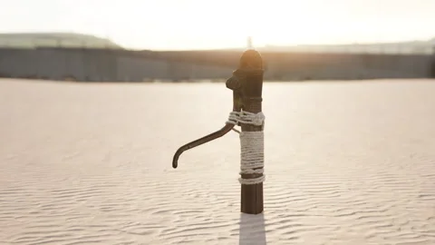 Rusty old metal water pump on sand beach Stock Footage 237597659