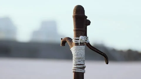 Rusty old metal water pump on sand beach Stock Footage 238752316