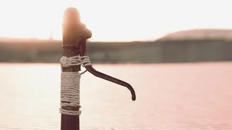Rusty old metal water pump on sand beach Stock Illustration