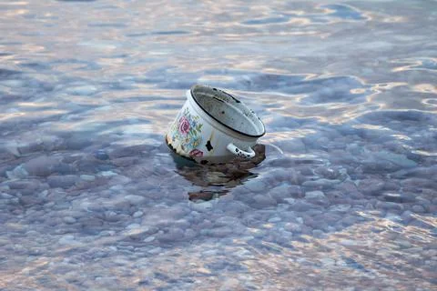 Rusty old pot in the water Stock Photos